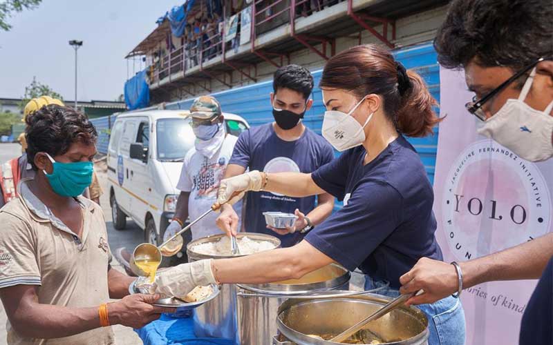 Jacqueline Fernandez volunteers to serve the meal to the needy